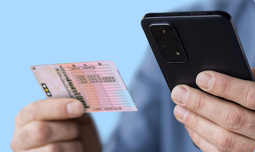 Person scanning their UK driving licence with their phone to prove their age