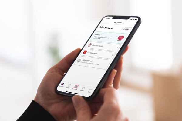 Person holding phone open on the Post office EasyID home screen