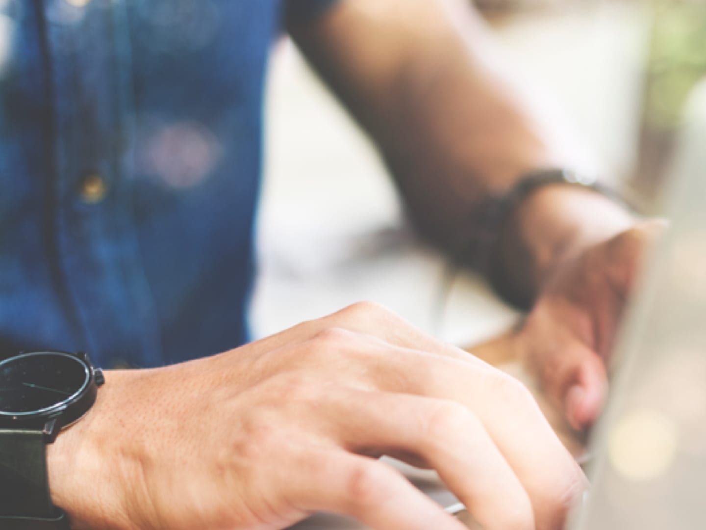Hands typing on laptop