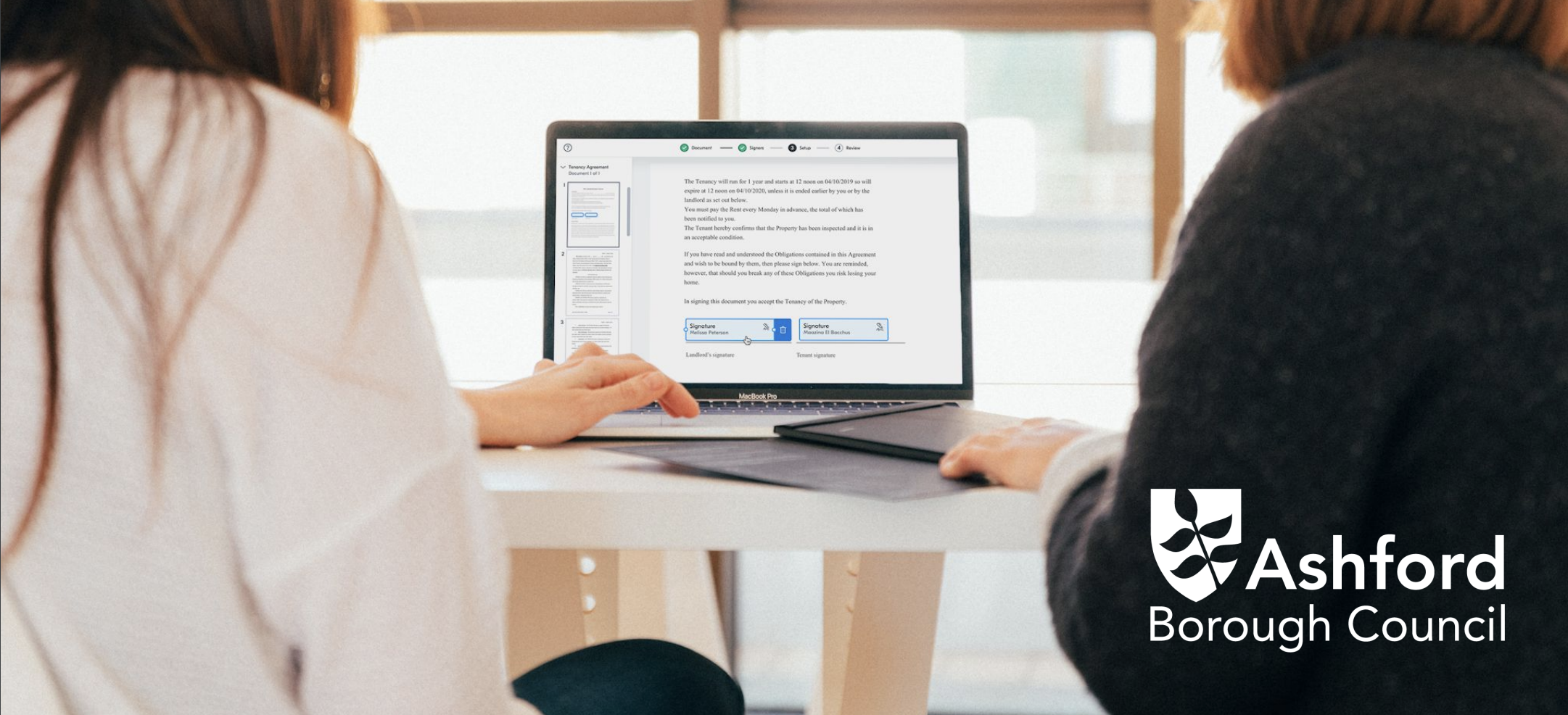 Two women at a laptop signing a document with Yoti eSignatures