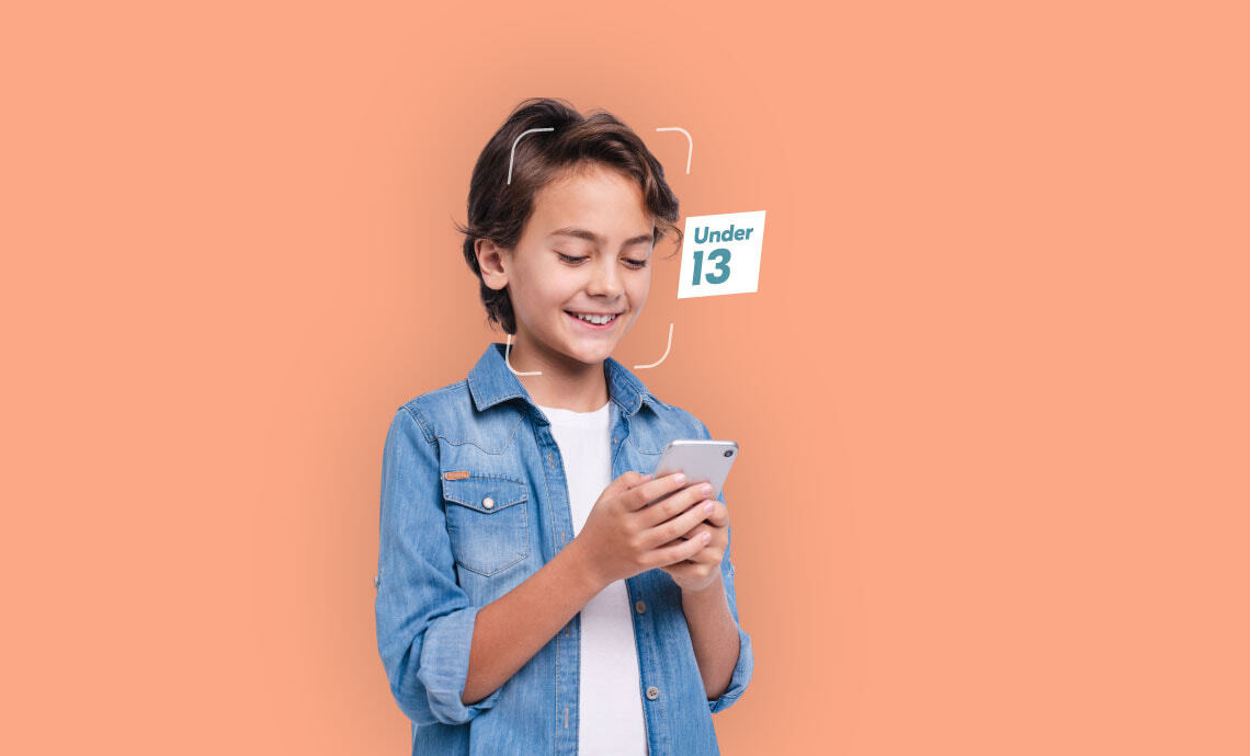 Teenager using their mobile phone with an Under 13 tag