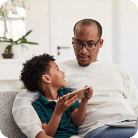 Dad and son using a smartphone together