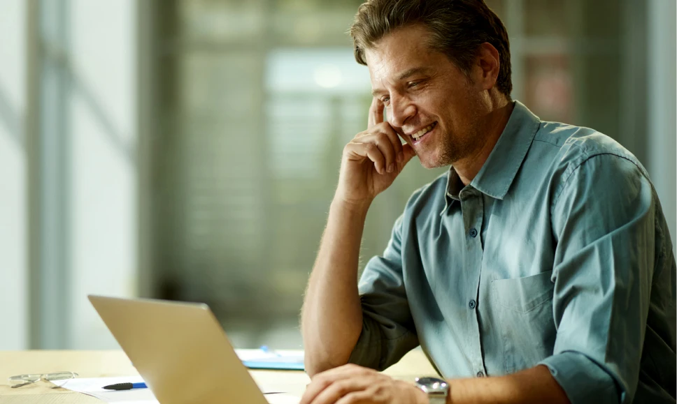 Man sat in office using laptop