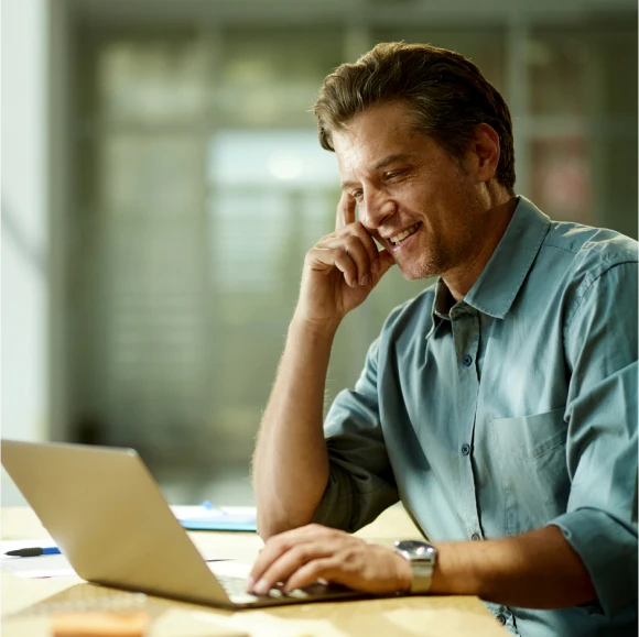 Man sat in office using laptop