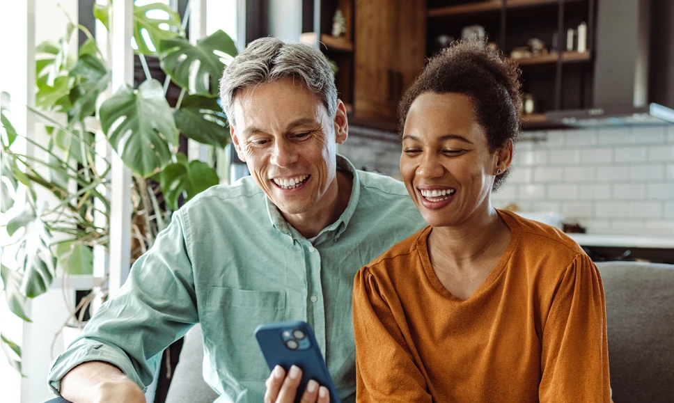 Man and woman looking at content on a smartphone together