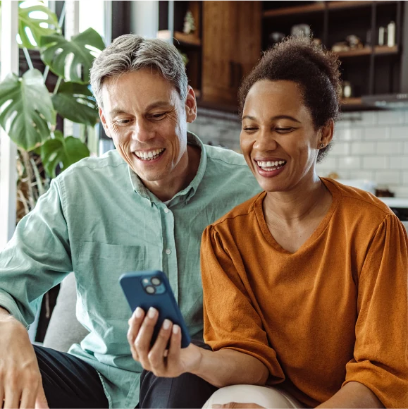 Man and woman looking at content on a smartphone together
