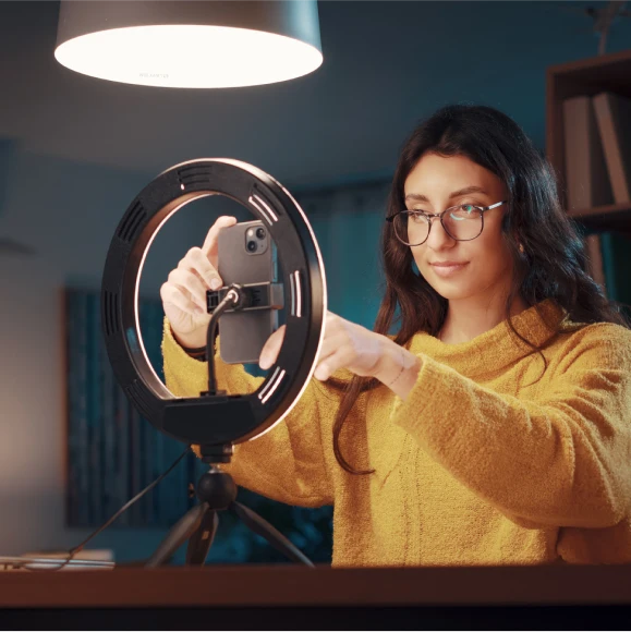 Woman content creator setting up a webcam
