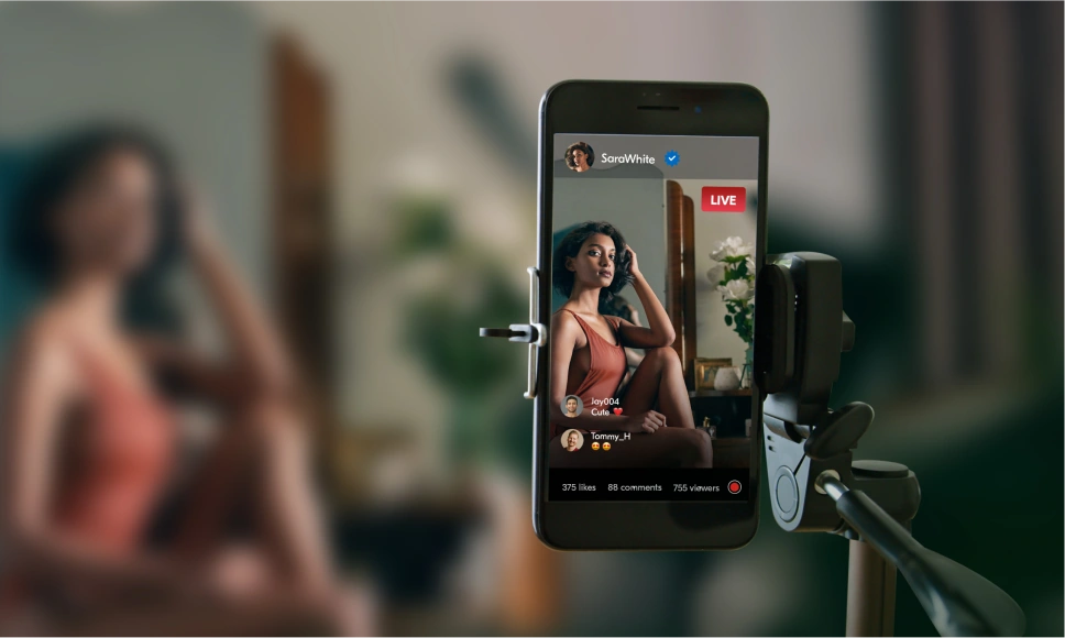 Woman filming an adult scene with her smartphone on a tripod