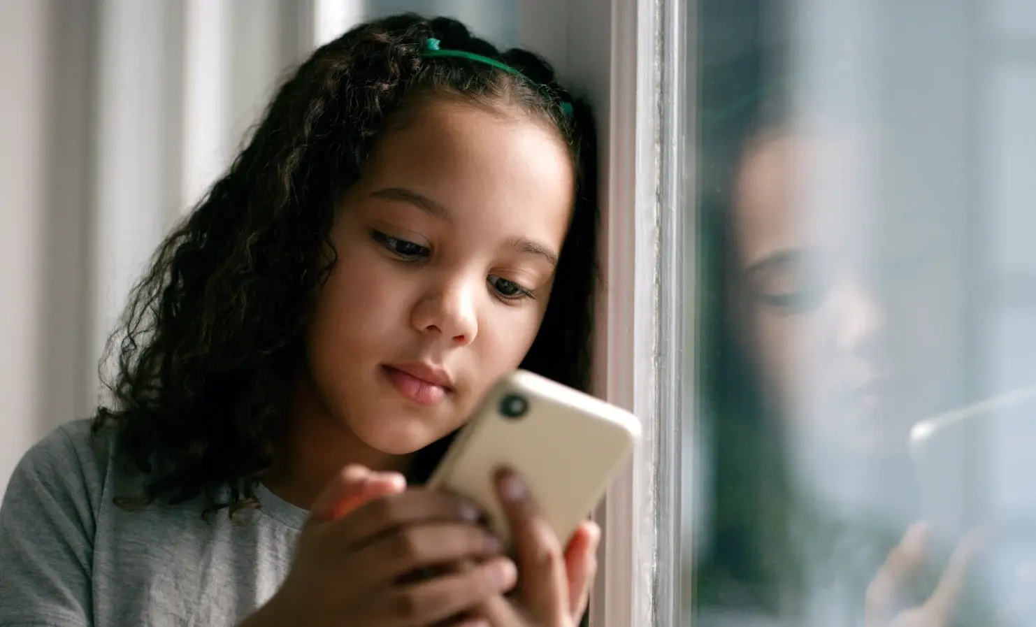 Young girl looking at smartphone