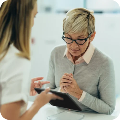Woman looking carefully of tablet being displayed.