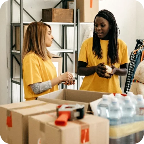 Two women organising donations at a Charity