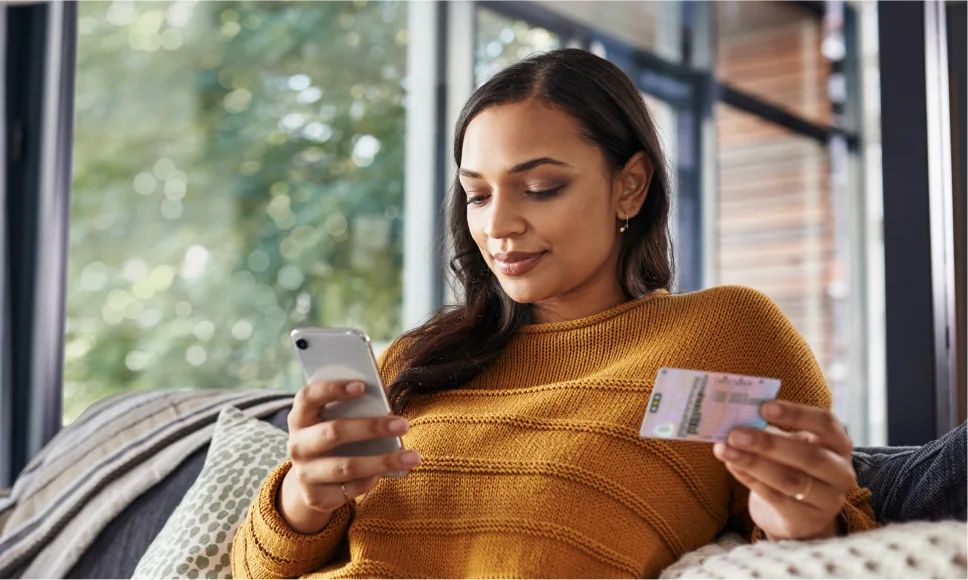 Woman putting her driving licence on her phone
