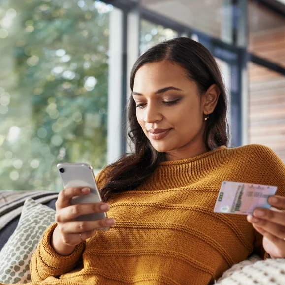 Woman putting her driving licence on her phone