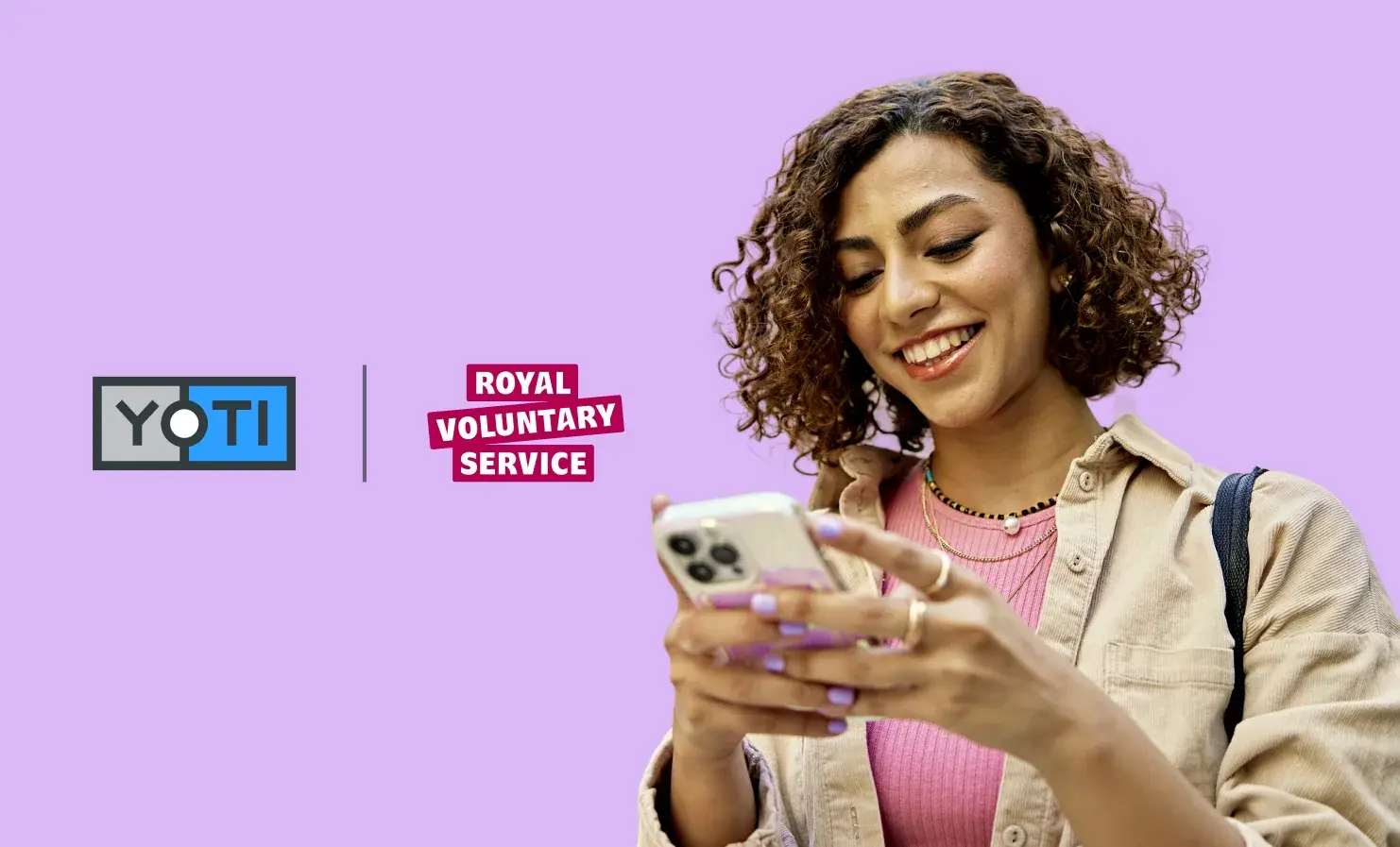 An image showing the Yoti logo beside the Royal Voluntary Service logo. To the right of the logos is a woman smiling and using her mobile phone.