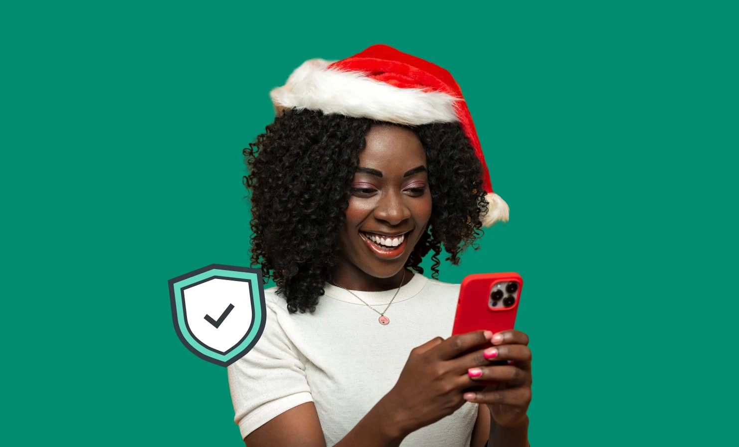 An image of a young woman wearing a Santa hat and smiling whilst she's using her mobile phone. An illustrative icon of a shield with a checkmark is next to her, representing the theme of security.