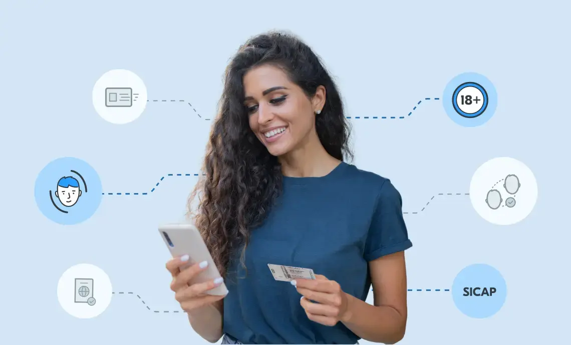 An image of a woman holding a driving licence in one hand and her mobile phone in another.