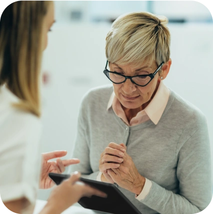 Post Office staff helping woman with tablet device